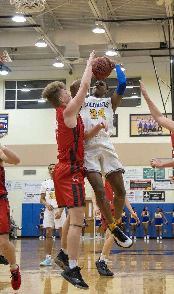 Lord Botetourt's (4) Kyle Arnholt goes for the block on William Fleming's (24) Donovan St. Juste.